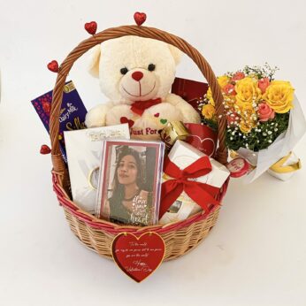 Enchanting happy Valentines Day gift basket with premium chocolates, photo frame, fresh flower bouquet and more