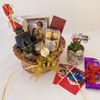 Charming first anniversary gifts for friends adorned with chocolates, wine, photo frame