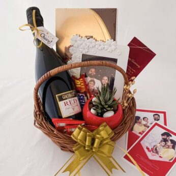 Exciting anniversary gift basket for friends with wine, chocolates, and greetings