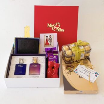 A blissful wedding gift for married couple contains a wallet, chocolates, & perfumes