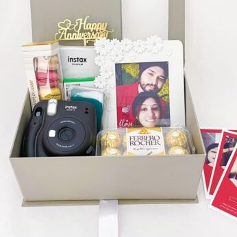 1 year anniversary gifts for husband contain sweets, a camera, and a photo frame