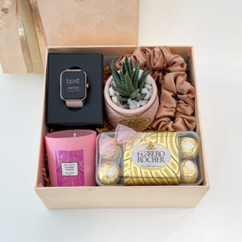 Personalized daughter’s day gift filled with a smartwatch, indoor plant, and chocolates