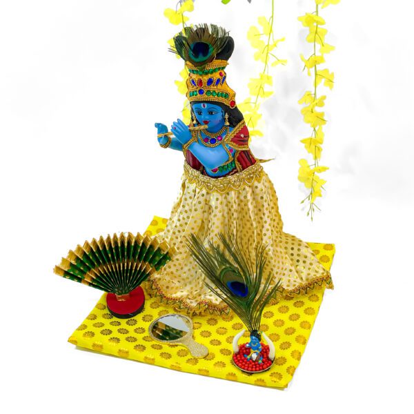 Elegant Valkannadi Mirror (H-4.5in, L-2.8in),Small Krishna Figurine (H-1.5in, L-2.2in), Thiru Udayada Statue (H-5in, L-8.5in) and Kanikonna flower - Image 2