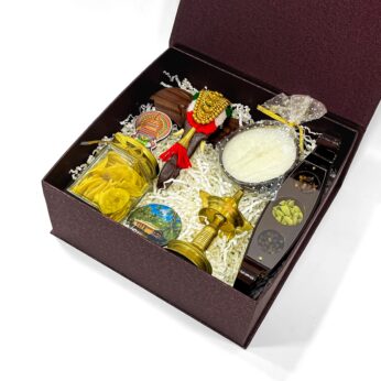 Kerala heritage gift box is filled with wooden elephant head, nilavilakku, and more